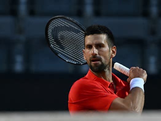 WATCH: Novak Djokovic drops to his knees after being struck on the head by a water bottle during the Italian Open.